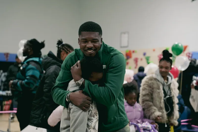 A KHA staff member hugging a child