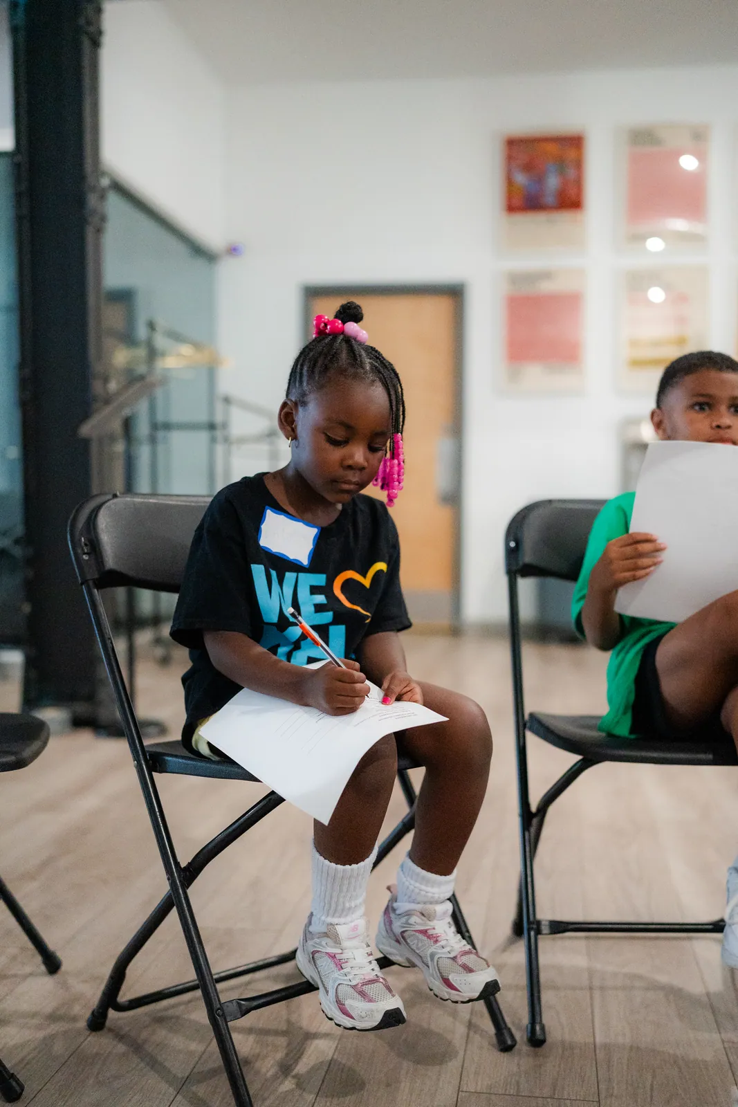 A young KHA participant learning to use a camera during Summer RISE