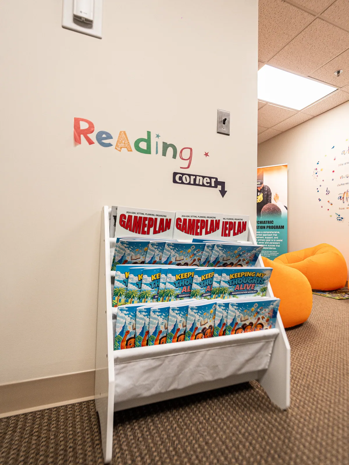 The children's reading corner at KHA with a book rack and colorful lettering