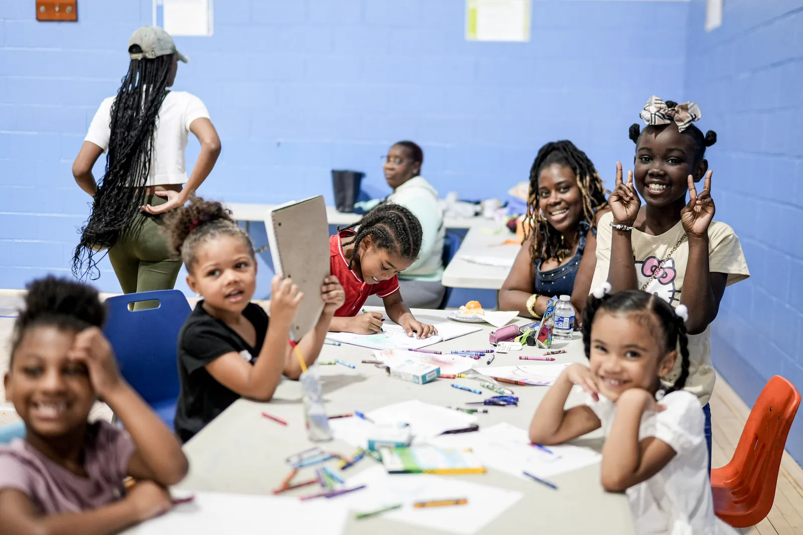 Children and adults coloring together at a KHA community activity