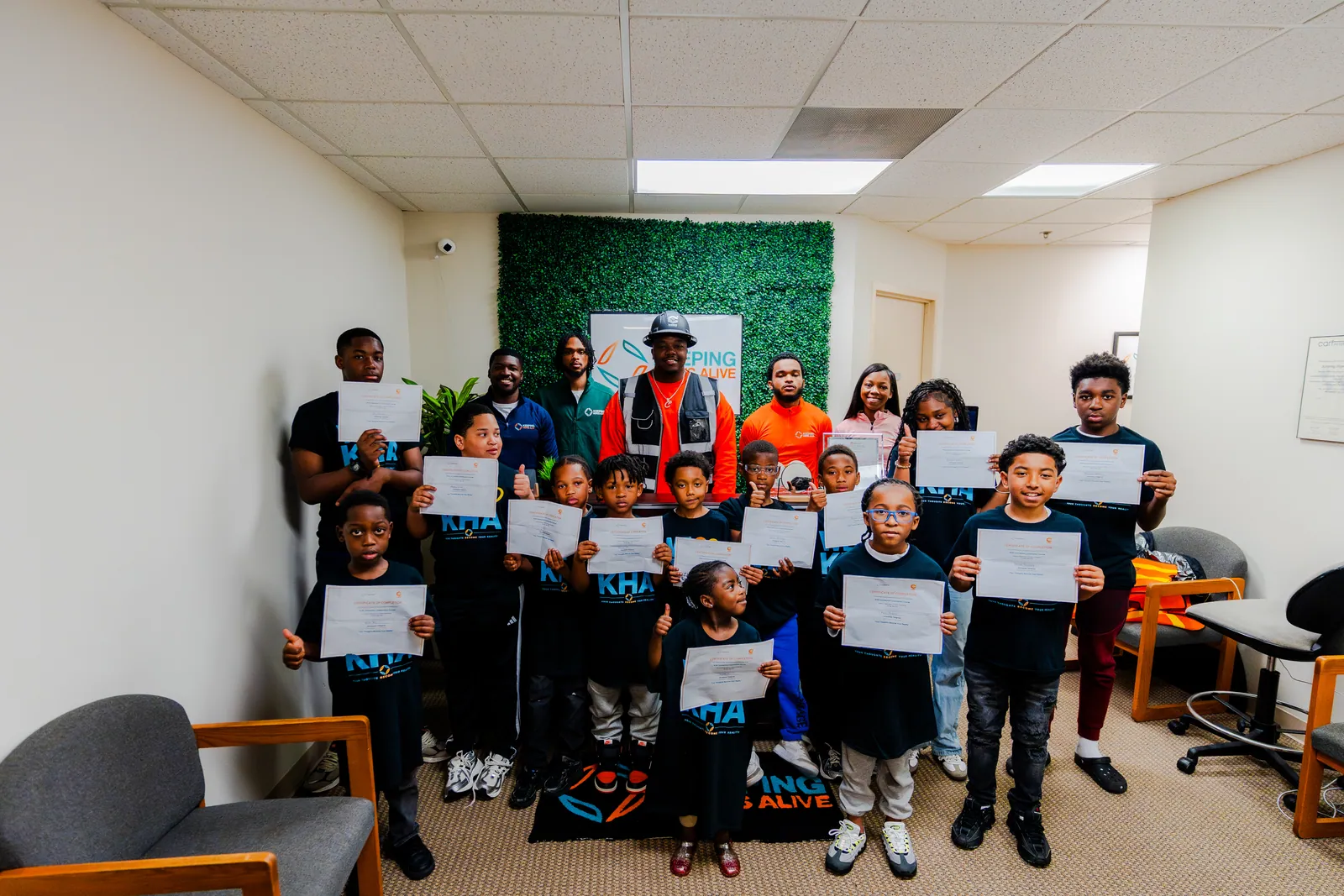KHA youth holding certificates after the construction workshop