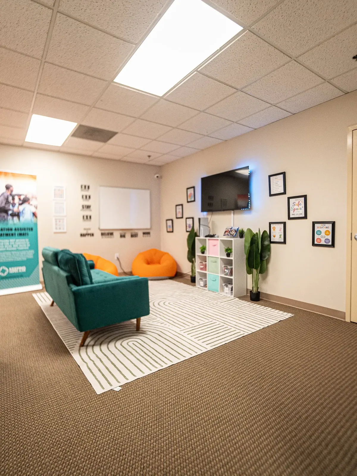 A comfortable group and family room with a sofa and bean bag chairs